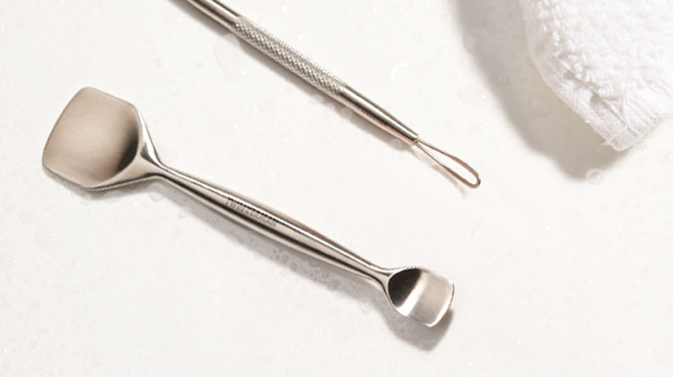 Metallic spatula and spoon on a white background
