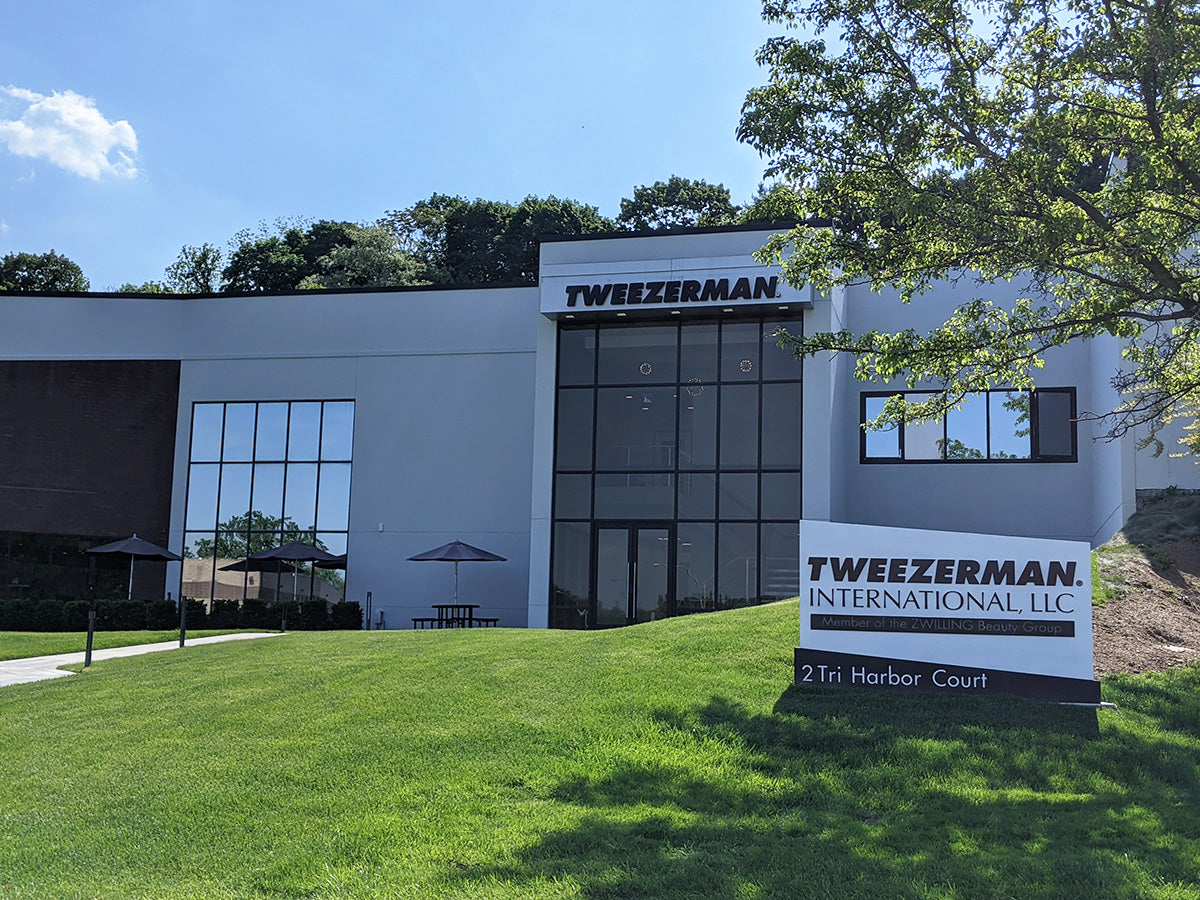 Tweezerman building with a sign in front on Tri Harbor Court