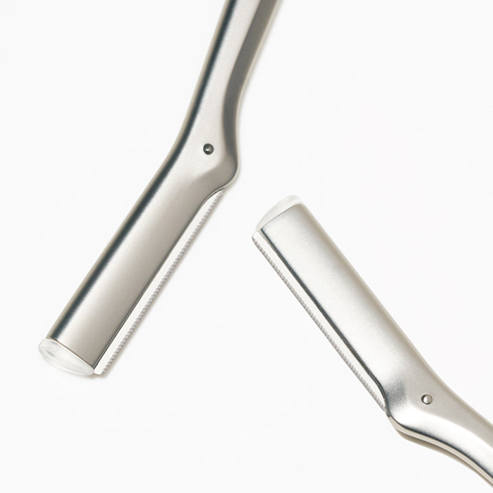 Two metallic objects resembling handles on a white background